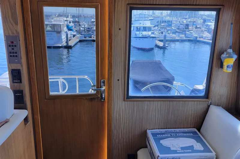 Southern Girl Yacht Photos Pics 1989 Hatteras Convertible interior with marina view through wooden door and window.