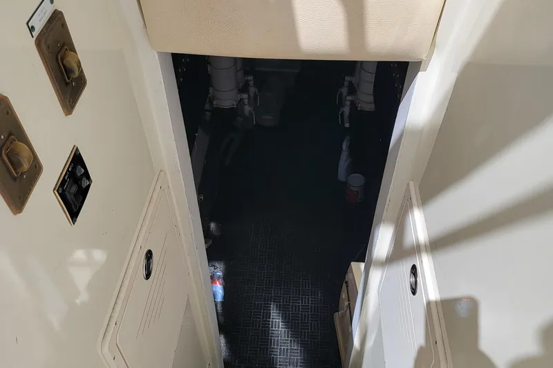 Southern Girl Yacht Photos Pics 1989 Hatteras Convertible engine room entrance with visible controls and storage compartments.