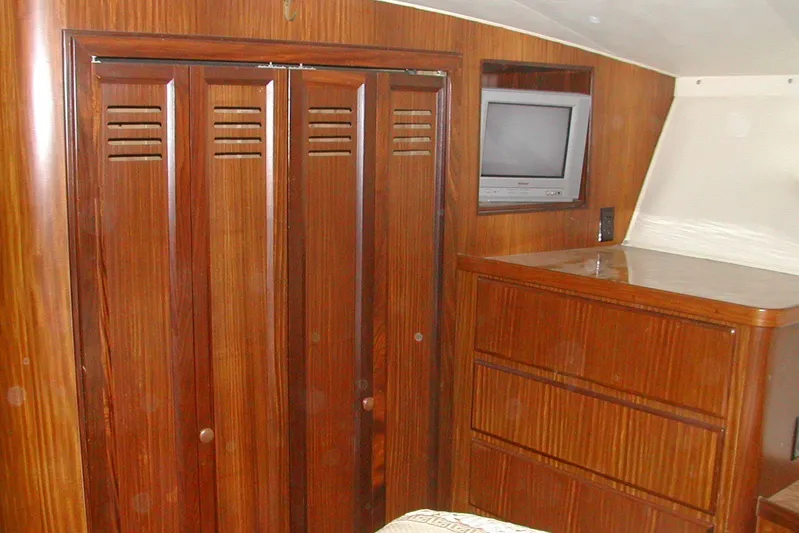 Southern Girl Yacht Photos Pics 1989 Hatteras Convertible yacht interior with wooden cabinets and built-in TV.