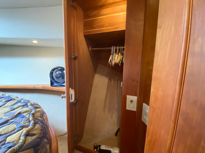 Aqua Holic Yacht Photos Pics 2002 Silverton 43 MY yacht interior with open wooden closet and bed.