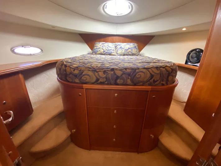 Aqua Holic Yacht Photos Pics Luxurious 2002 Silverton 43 MY yacht bedroom with elegant wood cabinetry and plush bedding.