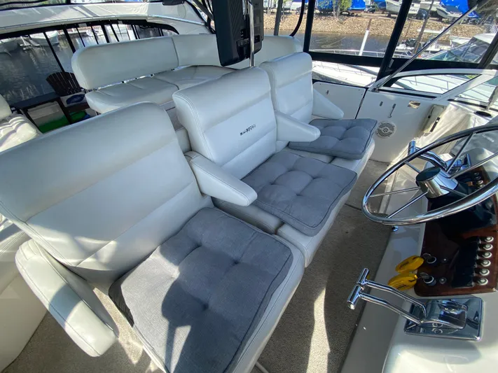 Aqua Holic Yacht Photos Pics Interior of 2002 Silverton 43 MY yacht with plush seating and steering wheel.