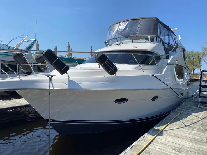 Aqua Holic Yacht Photos Pics 2002 Silverton 43 MY yacht docked at marina under clear blue sky.