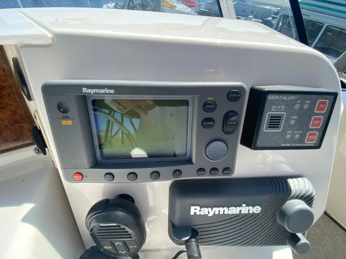 Aqua Holic Yacht Photos Pics Control panel of a 2002 Silverton 43 MY boat with Raymarine GPS and Safe-T-Alert system.