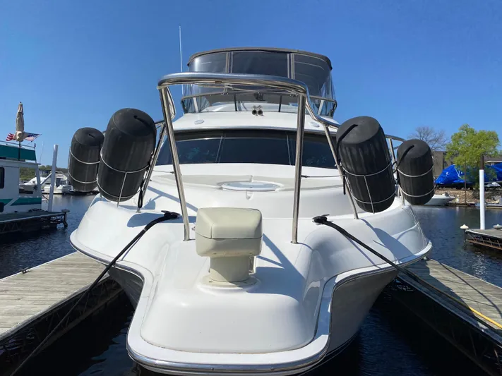 Aqua Holic Yacht Photos Pics 2002 Silverton 43 MY yacht docked at marina, front view with clear blue sky.