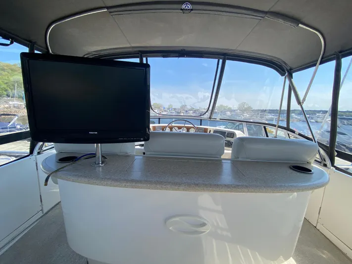 Aqua Holic Yacht Photos Pics Interior of 2002 Silverton 43 MY yacht with TV and helm view.