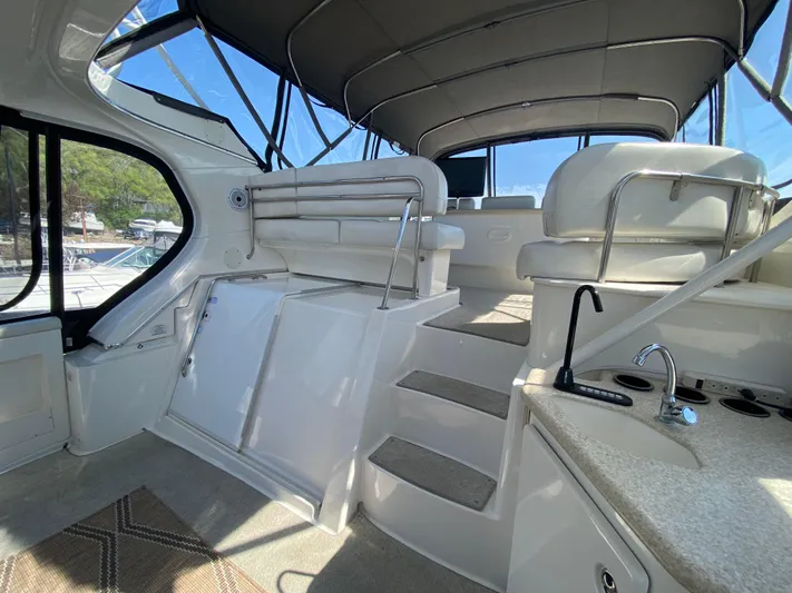 Aqua Holic Yacht Photos Pics Interior view of 2002 Silverton 43 MY yacht with seating and kitchenette.