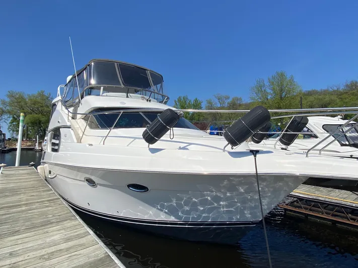 Aqua Holic Yacht Photos Pics 2002 Silverton 43 MY yacht docked, featuring sleek design and spacious upper deck.
