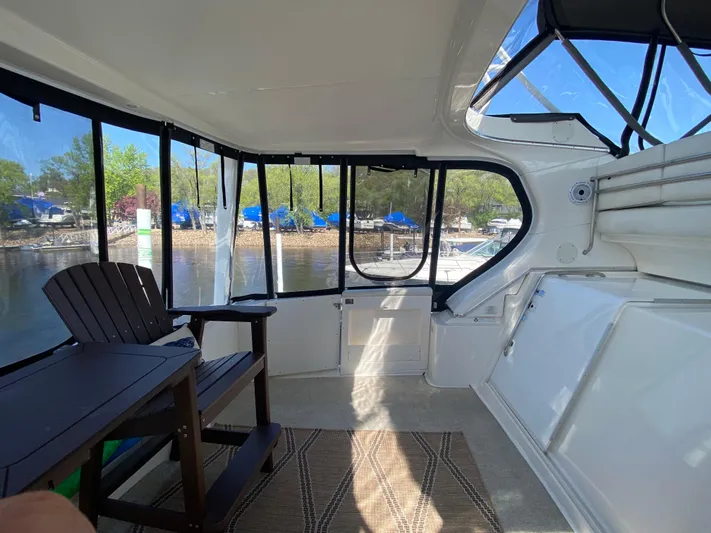 Aqua Holic Yacht Photos Pics Interior view of a 2002 Silverton 43 MY yacht with seating and water view.