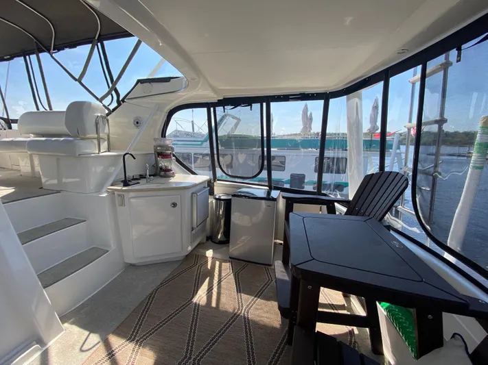 Aqua Holic Yacht Photos Pics Interior of 2002 Silverton 43 MY yacht with seating and panoramic windows.