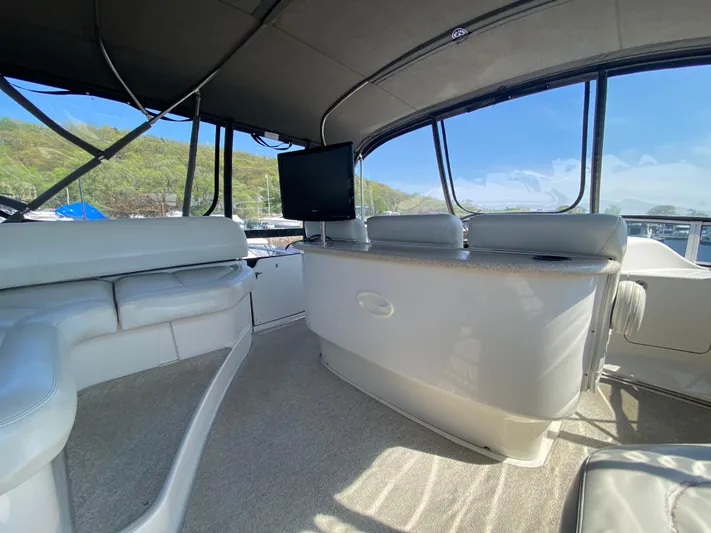 Aqua Holic Yacht Photos Pics Interior of 2002 Silverton 43 MY yacht with seating and TV, featuring large windows.