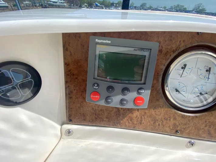 Aqua Holic Yacht Photos Pics Control panel of a 2002 Silverton 43 MY yacht with Raymarine autopilot and gauges.