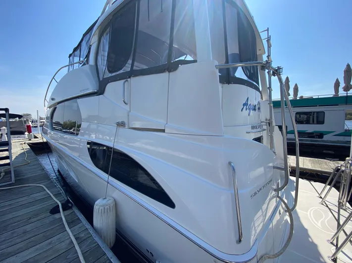 Aqua Holic Yacht Photos Pics 2002 Silverton 43 MY yacht docked under clear blue sky.