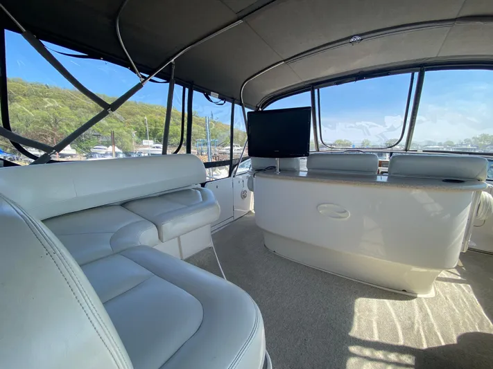 Aqua Holic Yacht Photos Pics Interior of 2002 Silverton 43 MY yacht with white seating and large windows.