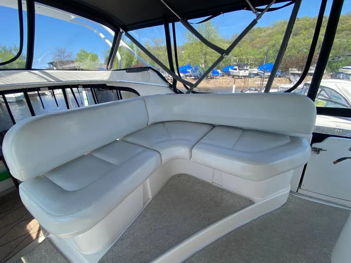 Aqua Holic Yacht Photos Pics 2002 Silverton 43 MY yacht interior with white leather seating and scenic marina view.