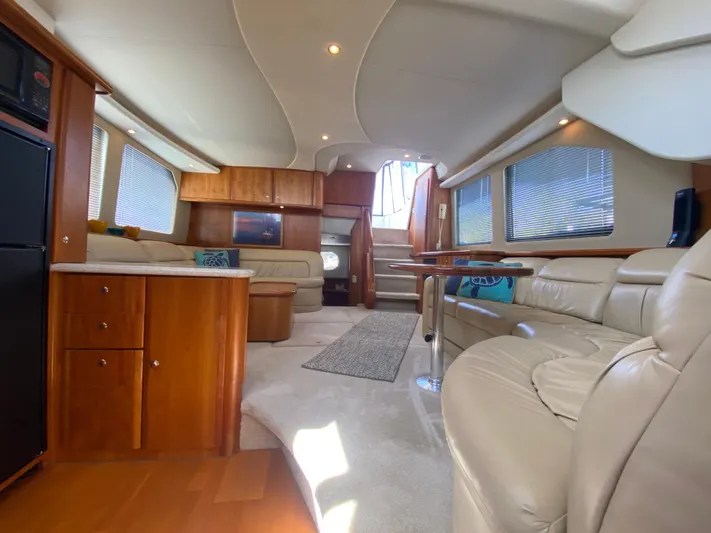 Aqua Holic Yacht Photos Pics Luxurious interior of 2002 Silverton 43 MY yacht with leather seating and wooden cabinetry.