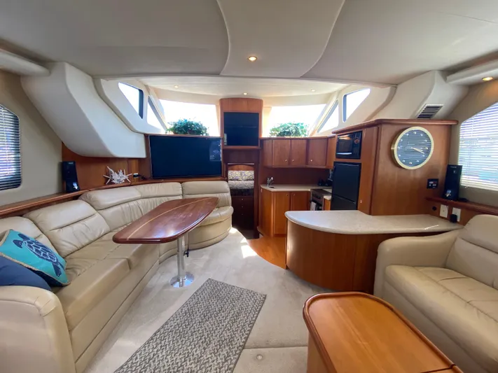 Aqua Holic Yacht Photos Pics Luxurious interior of 2002 Silverton 43 MY yacht with elegant seating and modern kitchen.