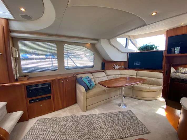 Aqua Holic Yacht Photos Pics Luxurious interior of a 2002 Silverton 43 MY yacht with plush seating and elegant wood finishes.