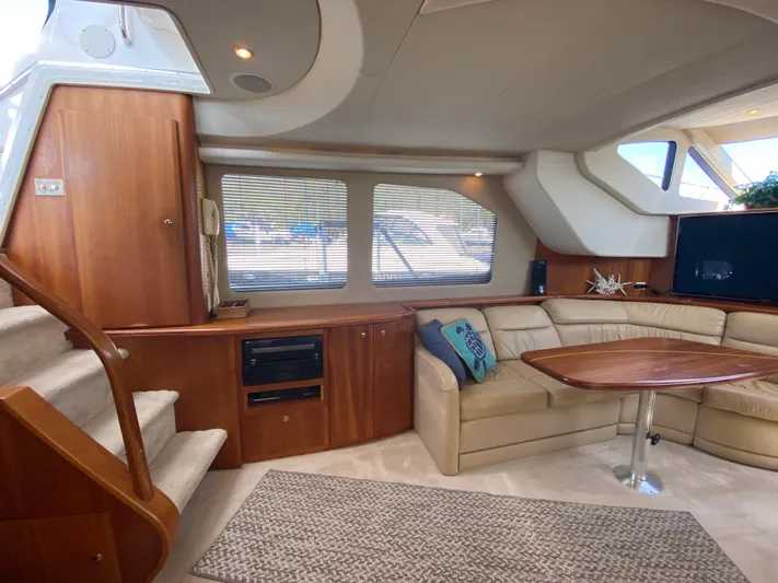 Aqua Holic Yacht Photos Pics Luxurious 2002 Silverton 43 MY yacht interior with plush seating and elegant wood finishes.