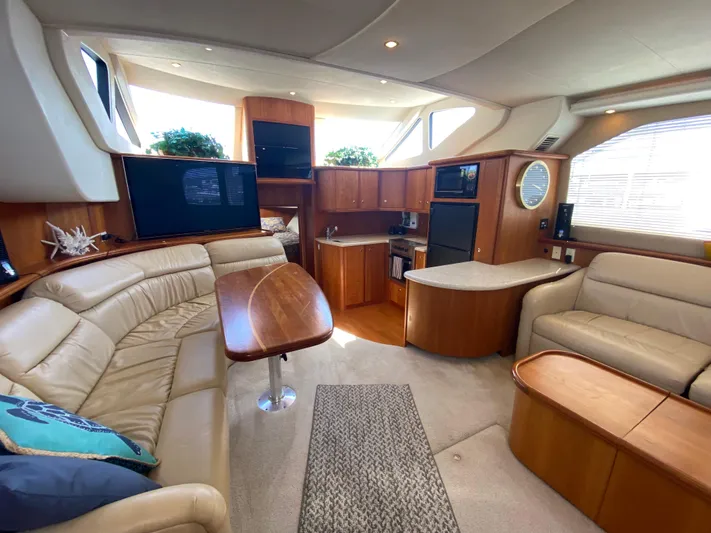 Aqua Holic Yacht Photos Pics Luxurious interior of a 2002 Silverton 43 MY yacht with leather seating and modern amenities.