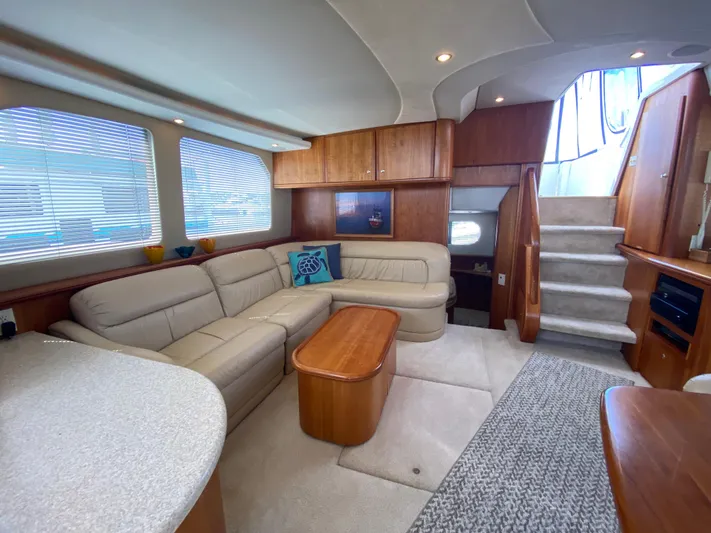 Aqua Holic Yacht Photos Pics Luxurious interior of 2002 Silverton 43 MY yacht with plush seating and elegant wood finishes.