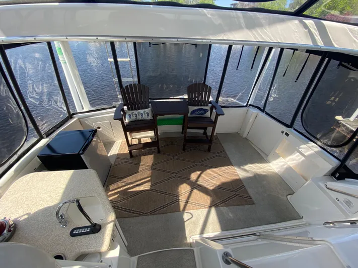 Aqua Holic Yacht Photos Pics Interior of 2002 Silverton 43 MY yacht with seating and kitchenette, overlooking water.