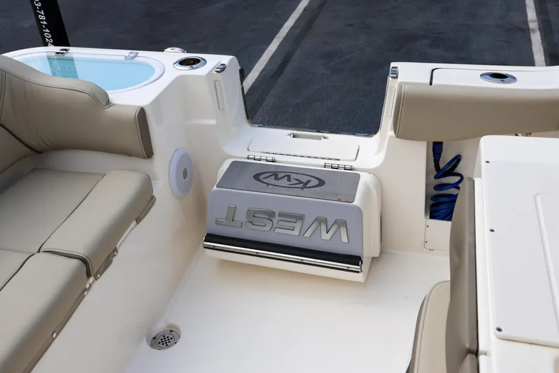  Yacht Photos Pics 2023 Key West 263 FS boat interior with beige seating and storage compartment.