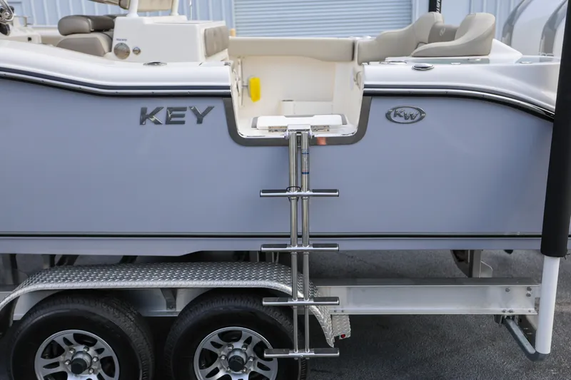  Yacht Photos Pics 2023 Key West 263 FS boat on trailer with ladder and seating area.
