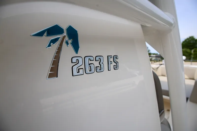  Yacht Photos Pics 2023 Key West 263 FS boat logo on white surface, featuring a palm tree design.