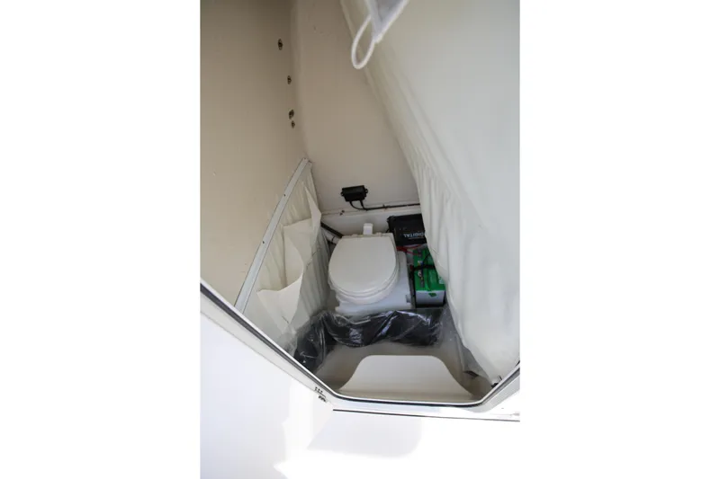  Yacht Photos Pics 2023 Key West 263 FS boat interior with compact toilet and storage area.
