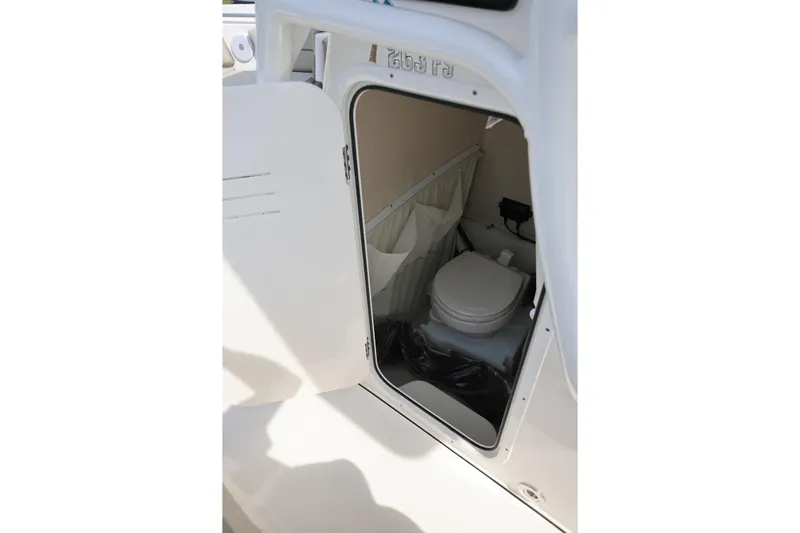  Yacht Photos Pics 2023 Key West 263 FS boat interior with open door revealing compact toilet.