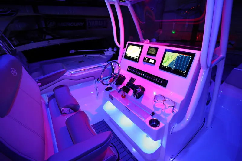  Yacht Photos Pics 2023 Key West 263 FS boat cockpit with illuminated controls and navigation screens.