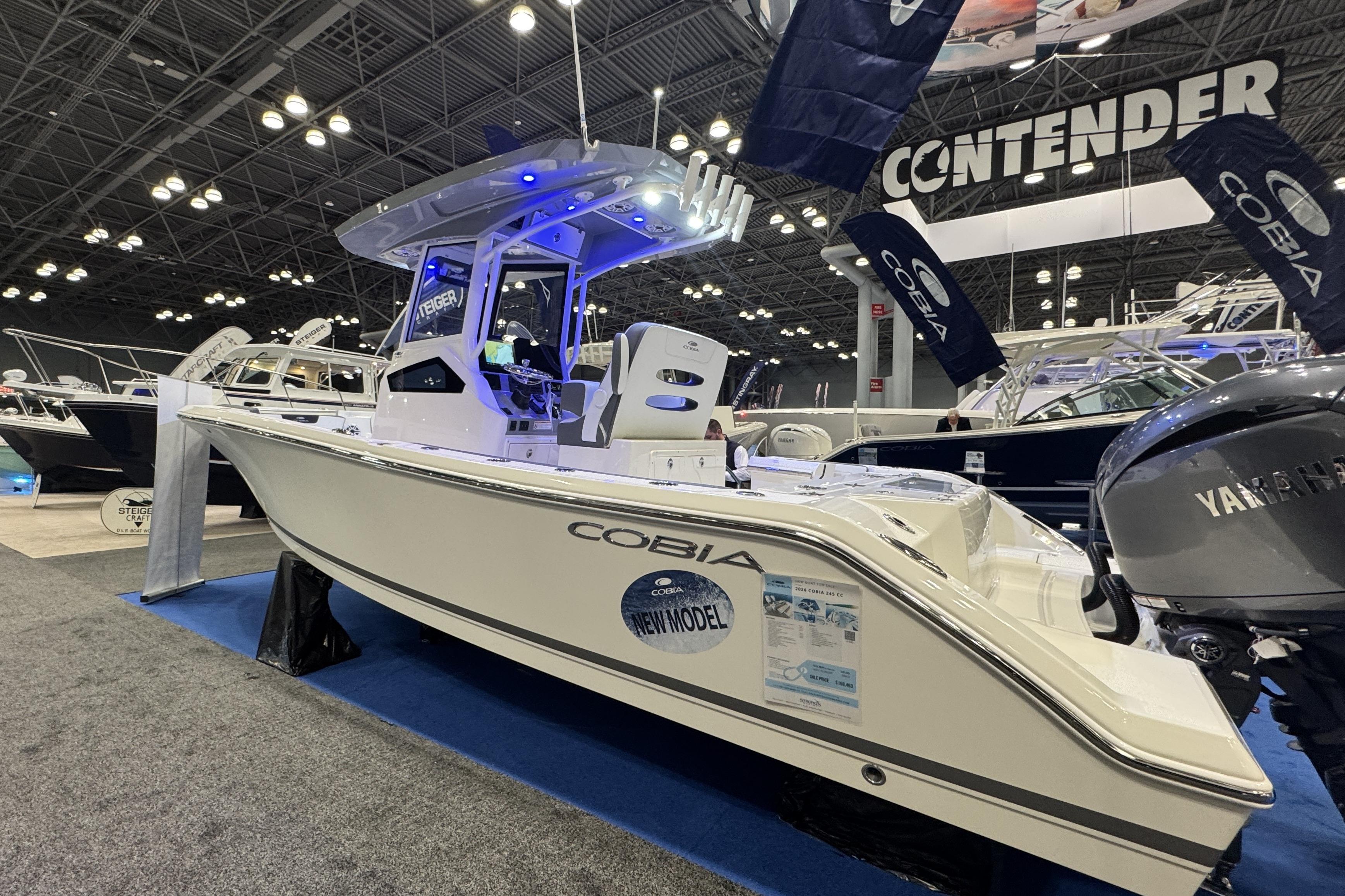 2026 Cobia 245 Center Console boat displayed at a boat show with Yamaha engine.