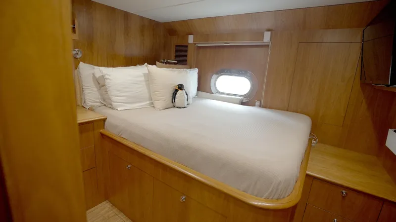 Homecoming Yacht Photos Pics Luxurious cabin interior of 2010 Horizon 136 Premier yacht with cozy bed and porthole.