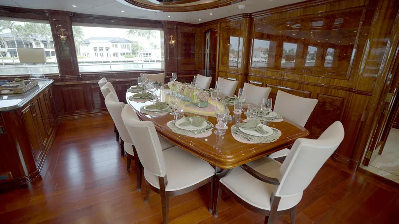 Homecoming Yacht Photos Pics Luxurious dining area on 2010 Horizon 136 Premier yacht with elegant wood finishes.
