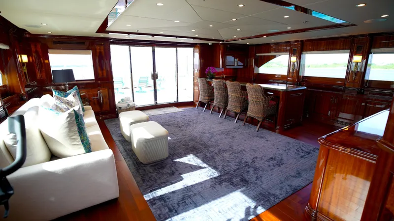 Homecoming Yacht Photos Pics Luxurious interior of 2010 Horizon 136 Premier yacht with elegant seating and rich wood finishes.