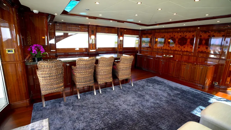 Homecoming Yacht Photos Pics Luxurious yacht interior with wooden decor, bar seating, and plush carpet, Horizon 136 Premier 2010.