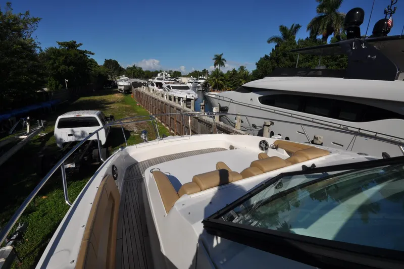  Yacht Photos Pics 2020 Sea Ray Sundancer 320 docked, surrounded by yachts and lush greenery.