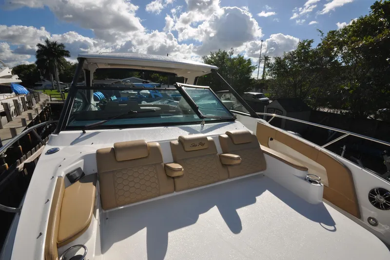  Yacht Photos Pics 2020 Sea Ray Sundancer 320 boat with spacious deck and luxurious seating under a sunny sky.