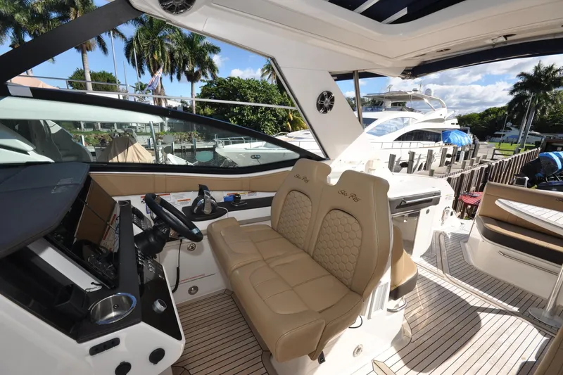  Yacht Photos Pics Interior view of 2020 Sea Ray Sundancer 320 yacht with luxurious seating and modern dashboard.