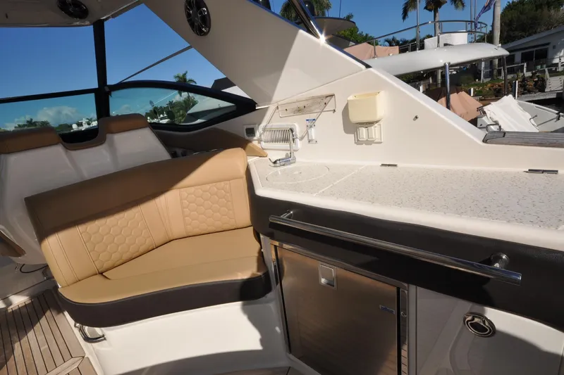  Yacht Photos Pics 2020 Sea Ray Sundancer 320 interior with beige seating and kitchenette area.