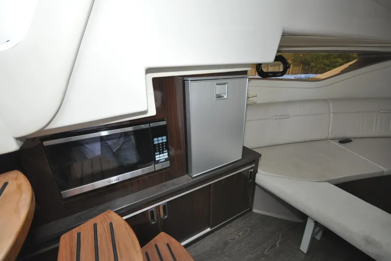  Yacht Photos Pics Interior of 2020 Sea Ray Sundancer 320 with kitchenette and seating area.
