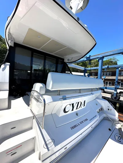  Yacht Photos Pics 2022 Regal 42 Grande Coupe yacht docked, rear view with CYDA name.