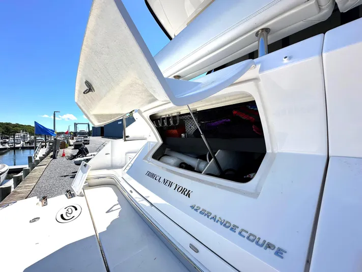  Yacht Photos Pics 2022 Regal 42 Grande Coupe yacht docked with open storage compartment.