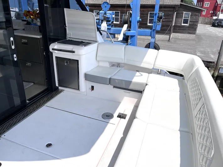  Yacht Photos Pics 2022 Regal 42 Grande Coupe yacht with white seating and outdoor kitchenette.