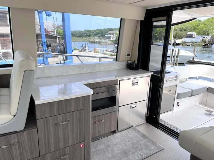  Yacht Photos Pics Interior of 2022 Regal 42 Grande Coupe yacht with modern kitchen and scenic marina view.
