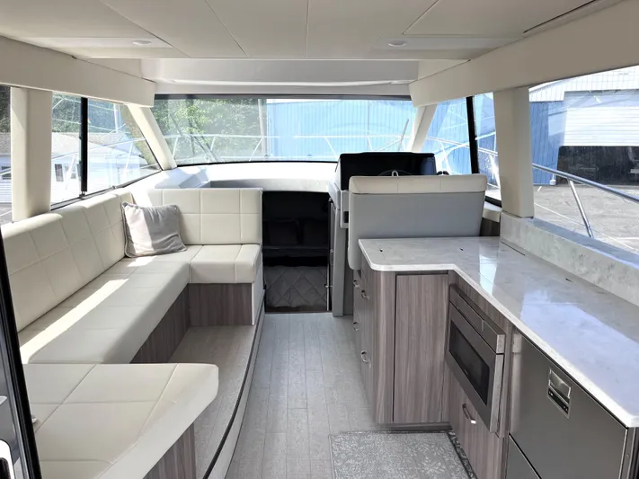  Yacht Photos Pics Interior of 2022 Regal 42 Grande Coupe yacht with modern seating and kitchen area.