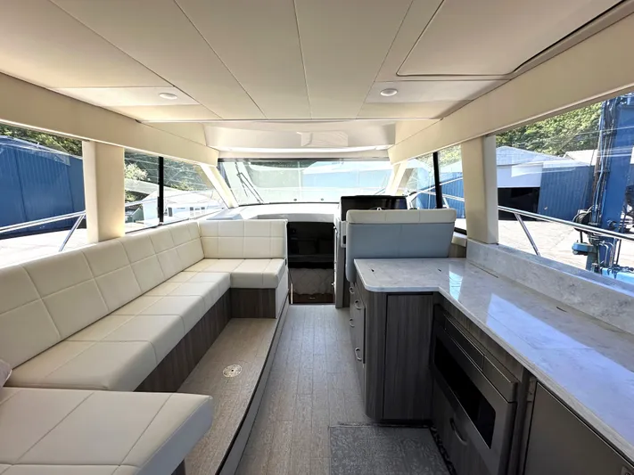  Yacht Photos Pics Interior of 2022 Regal 42 Grande Coupe yacht with modern seating and kitchen area.