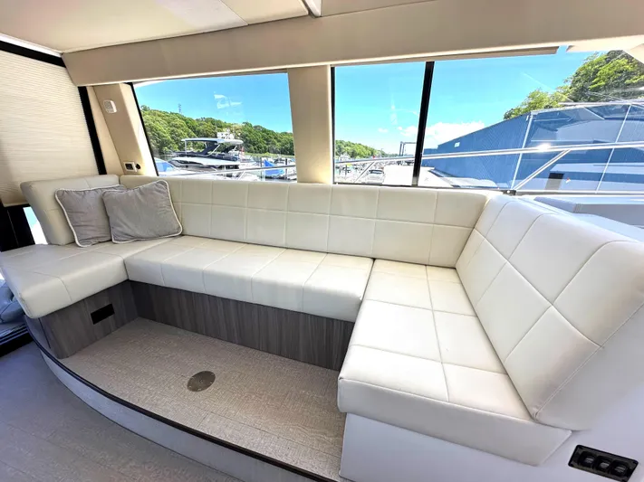  Yacht Photos Pics Luxurious interior seating of 2022 Regal 42 Grande Coupe yacht with scenic window views.