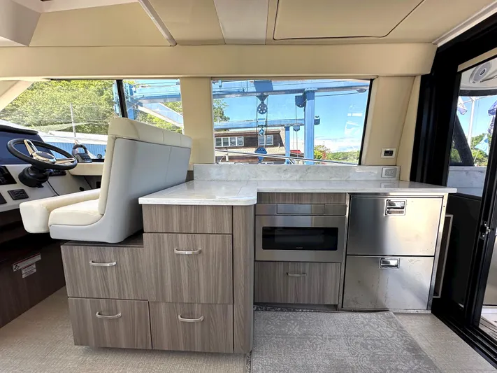  Yacht Photos Pics Interior of 2022 Regal 42 Grande Coupe yacht with modern kitchen and helm station.